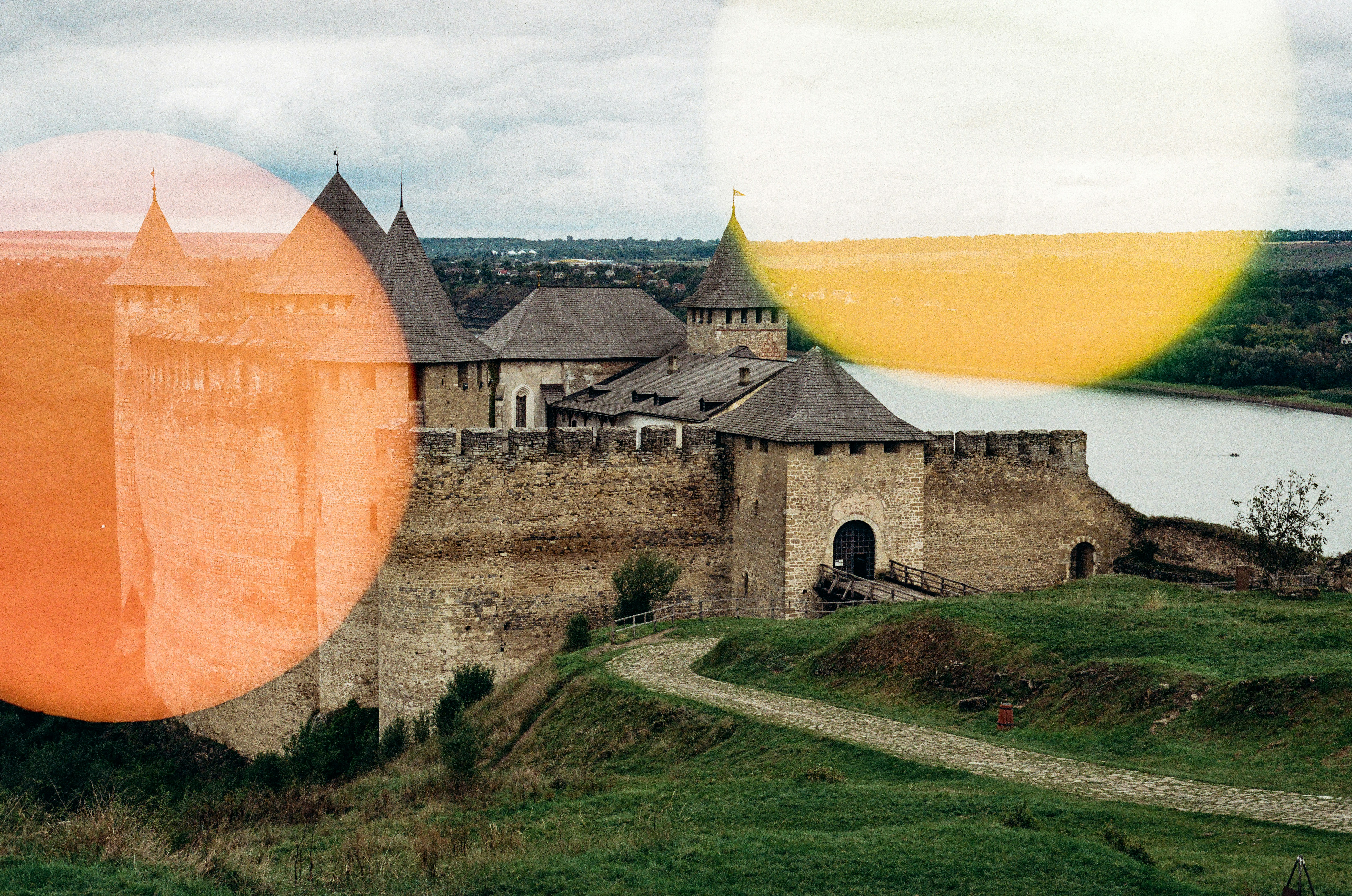 Ancient stone fortress on a grassy hill near water